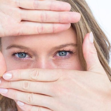 Pretty hipster doing frame with her hands on white background