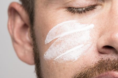 portrait-handsome-man-using-face-cream-close-up